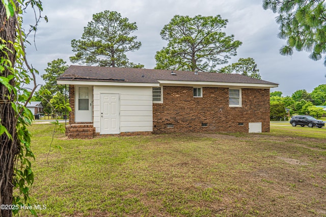 137 Pinecrest Trl, Rockingham, NC 28379 - rear view of house featuring crawl space, a yard, entry steps, and brick siding
