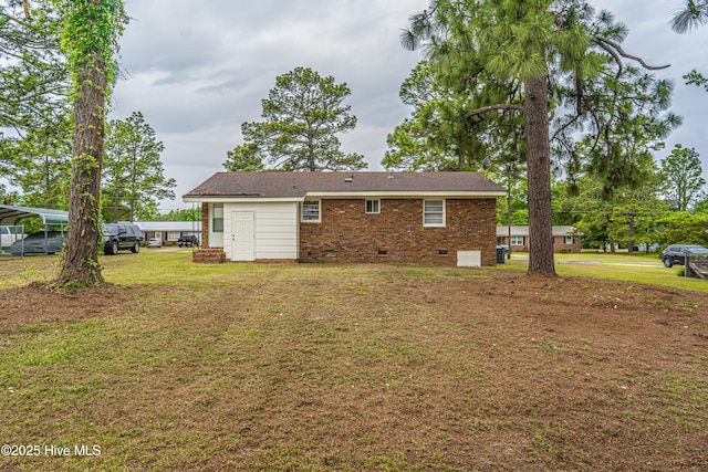 137 Pinecrest Trl, Rockingham, NC 28379 - back of house with crawl space, a lawn, and brick siding