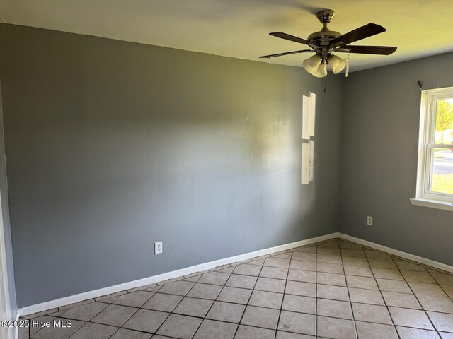 7 Walnut Dr, Jacksonville, NC 28546 - empty room with a ceiling fan, baseboards, and light tile patterned flooring