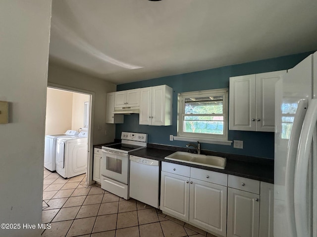 7 Walnut Dr, Jacksonville, NC 28546 - kitchen featuring white appliances, a sink, independent washer and dryer, under cabinet range hood, and dark countertops
