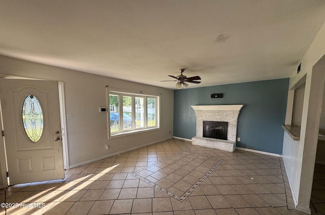 7 Walnut Dr, Jacksonville, NC 28546 - foyer with a ceiling fan, light tile patterned floors, a fireplace, and baseboards
