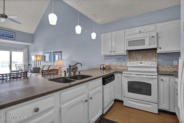 1912 Goose Creek Rd SW Unit 4302, Ocean Isle Beach, NC 28469 - kitchen with white appliances, a sink, high vaulted ceiling, white cabinetry, and ceiling fan