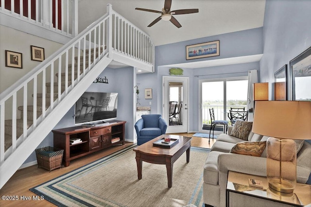 1912 Goose Creek Rd SW Unit 4302, Ocean Isle Beach, NC 28469 - living room with stairs, ceiling fan, high vaulted ceiling, wood finished floors, and baseboards
