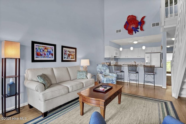 1912 Goose Creek Rd SW Unit 4302, Ocean Isle Beach, NC 28469 - living area featuring a towering ceiling, wood finished floors, and baseboards