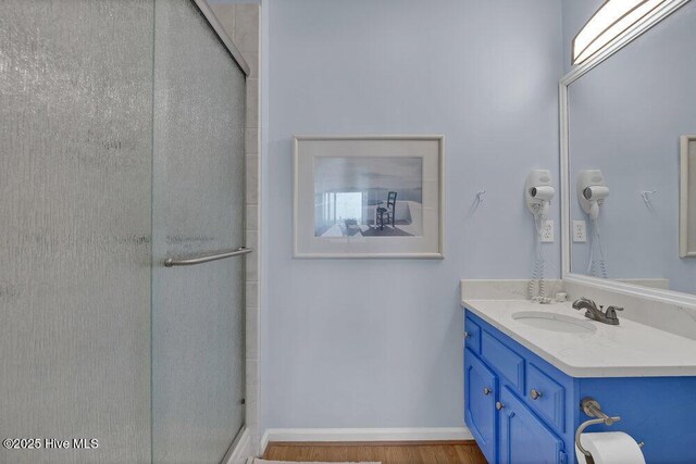 1912 Goose Creek Rd SW Unit 4302, Ocean Isle Beach, NC 28469 - bathroom featuring vanity, a stall shower, and wood finished floors