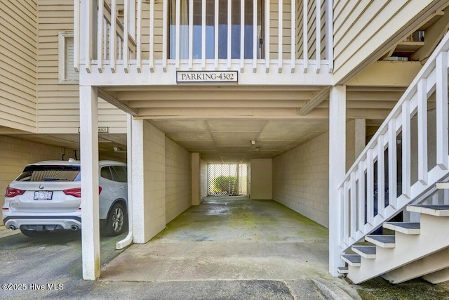 1912 Goose Creek Rd SW Unit 4302, Ocean Isle Beach, NC 28469 - view of vehicle parking featuring a carport and stairs