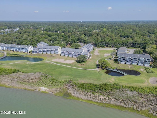 1912 Goose Creek Rd SW Unit 4302, Ocean Isle Beach, NC 28469 - drone / aerial view of a golf course, a large body of water, a heavily wooded area, and apartment complex / building