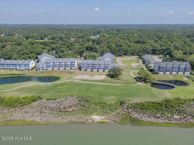 1912 Goose Creek Rd SW Unit 4302, Ocean Isle Beach, NC 28469 - drone / aerial view of a heavily wooded area, a local golf course, a nearby body of water, and apartment complex