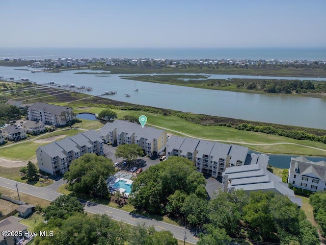 1912 Goose Creek Rd SW Unit 4302, Ocean Isle Beach, NC 28469 - drone / aerial view of apartment complex / building, a large body of water, and a golf course