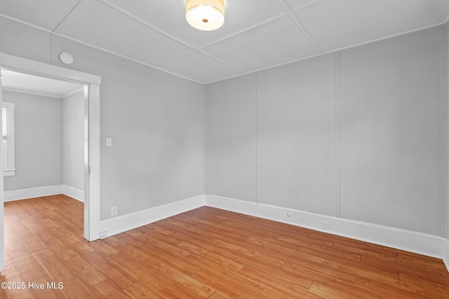 unfurnished room featuring light wood finished floors and baseboards