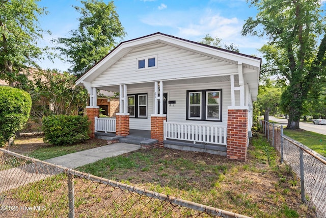 view of front of house featuring a porch and brick siding