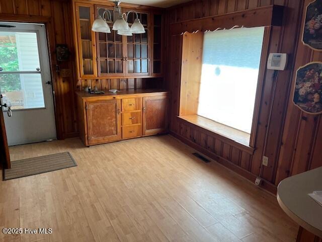 1616 Hwy 58 S, Snow Hill, NC 28580 - dining space featuring wooden walls, light wood-type flooring, and a chandelier
