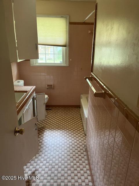 1616 Hwy 58 S, Snow Hill, NC 28580 - full bathroom with toilet, tile walls, vanity, and shower / tub combination