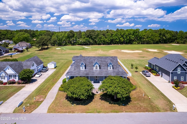 bird's eye view of a golf course and a tree filled landscape