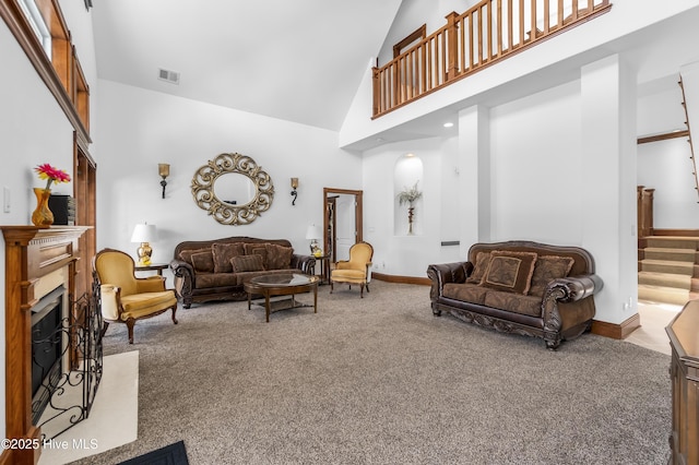 living room with high vaulted ceiling, carpet floors, a fireplace, stairway, and baseboards