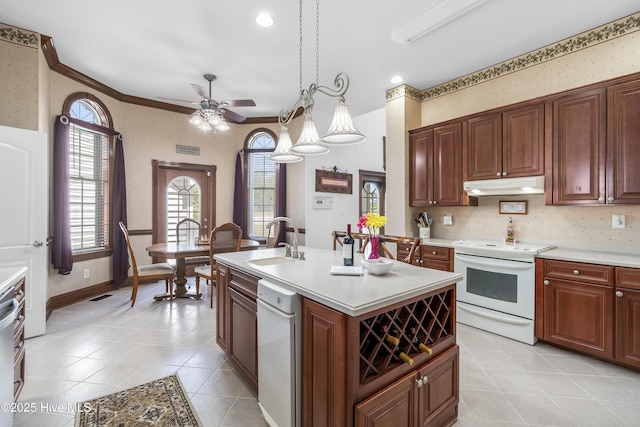 kitchen with white appliances, a sink, under cabinet range hood, wallpapered walls, and a ceiling fan