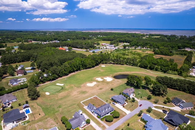 aerial overview of property's location with a large body of water, a golf club, and nearby suburban area