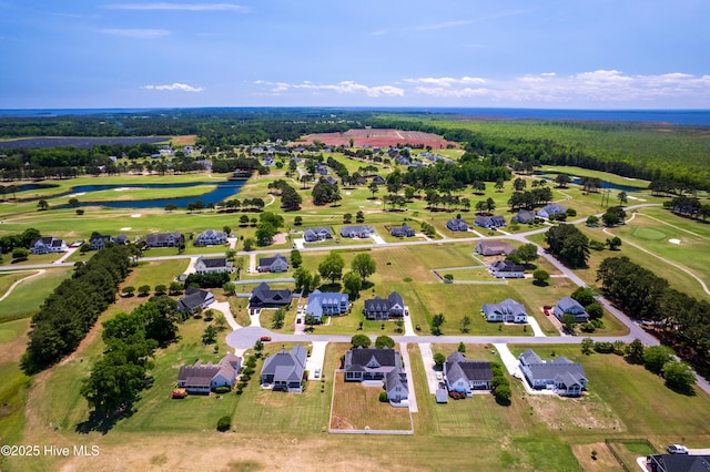 aerial perspective of suburban area featuring a nearby body of water and a golf club