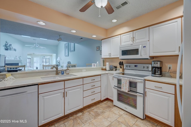 6025 Inland Greens Dr, Wilmington, NC 28405 - kitchen with white appliances, ceiling fan, a sink, white cabinetry, and recessed lighting