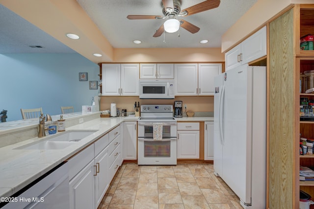 6025 Inland Greens Dr, Wilmington, NC 28405 - kitchen featuring white appliances, a sink, white cabinets, and recessed lighting