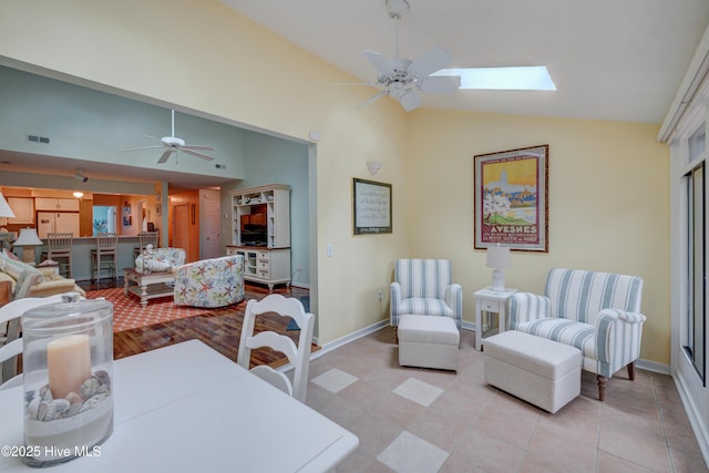 6025 Inland Greens Dr, Wilmington, NC 28405 - dining room featuring a ceiling fan, baseboards, high vaulted ceiling, a skylight, and light tile patterned floors