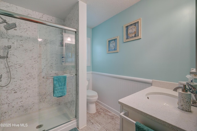 6025 Inland Greens Dr, Wilmington, NC 28405 - full bathroom with toilet, wainscoting, a marble finish shower, and vanity
