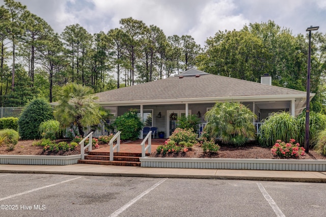6025 Inland Greens Dr, Wilmington, NC 28405 - ranch-style home featuring uncovered parking, covered porch, and a chimney