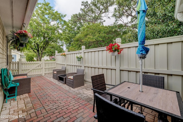 6025 Inland Greens Dr, Wilmington, NC 28405 - view of patio with a fenced backyard and outdoor dining space