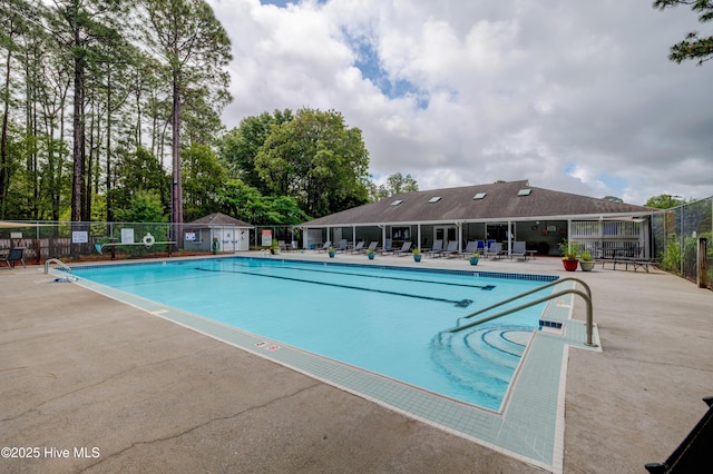 6025 Inland Greens Dr, Wilmington, NC 28405 - community pool with fence, a patio area, and view of wooded area