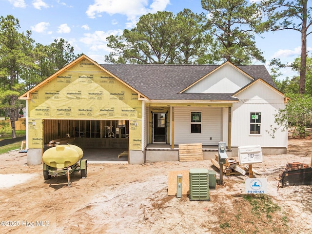 3122 Oak Dr SW, Shallotte, NC 28470 - property under construction featuring a shingled roof, a porch, and a garage