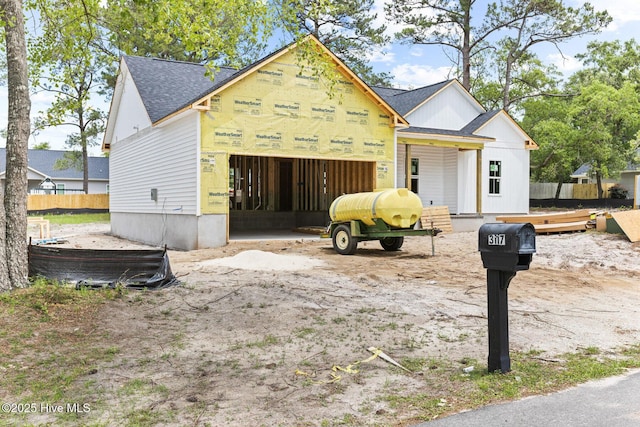3122 Oak Dr SW, Shallotte, NC 28470 - view of front facade with a garage, roof with shingles, and fence