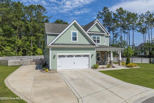 craftsman house with concrete driveway, covered porch, an attached garage, and roof with shingles