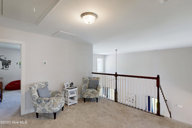 sitting room with attic access and carpet floors