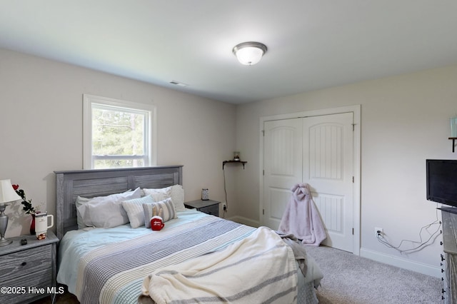 bedroom with a closet, carpet floors, and baseboards