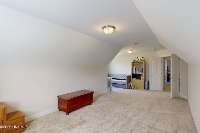 additional living space featuring carpet, vaulted ceiling, and baseboards