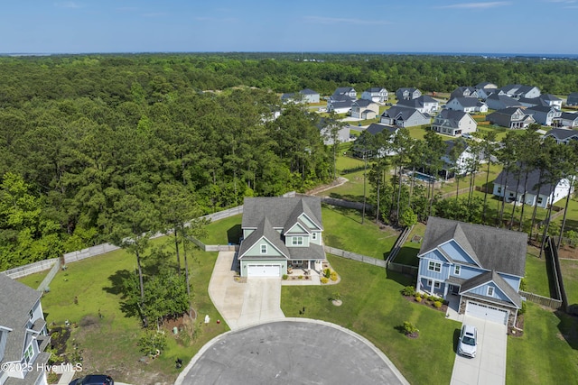 aerial view of property's location with a forest and nearby suburban area