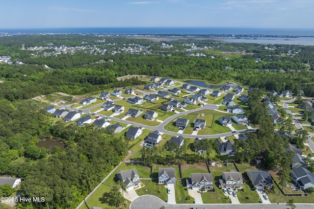 view of property location featuring a nearby body of water and nearby suburban area