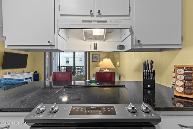 kitchen featuring electric range and white cabinetry