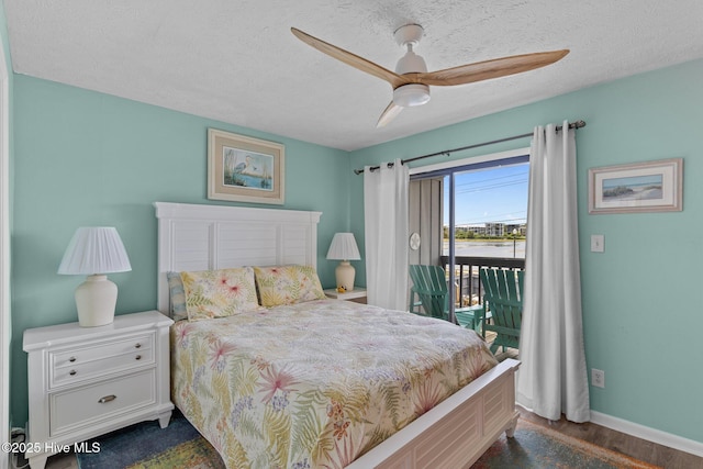 bedroom with access to exterior, dark wood-style floors, baseboards, a textured ceiling, and a ceiling fan