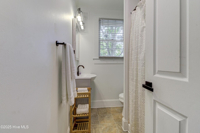 full bath with toilet, tile patterned flooring, vanity, and baseboards