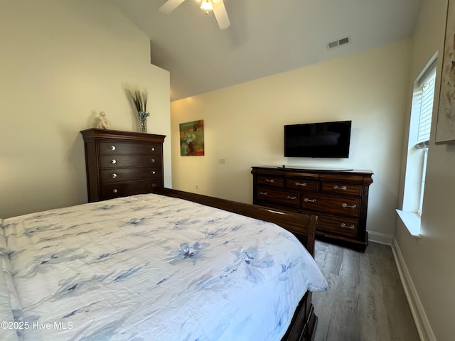 4983 Kona Ct Unit 1, Southport, NC 28461 - bedroom with wood finished floors, lofted ceiling, baseboards, and a ceiling fan