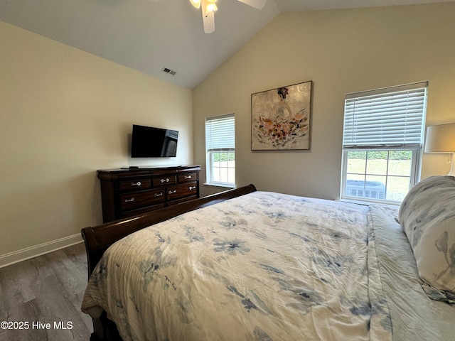 4983 Kona Ct Unit 1, Southport, NC 28461 - bedroom featuring wood finished floors, baseboards, multiple windows, high vaulted ceiling, and ceiling fan