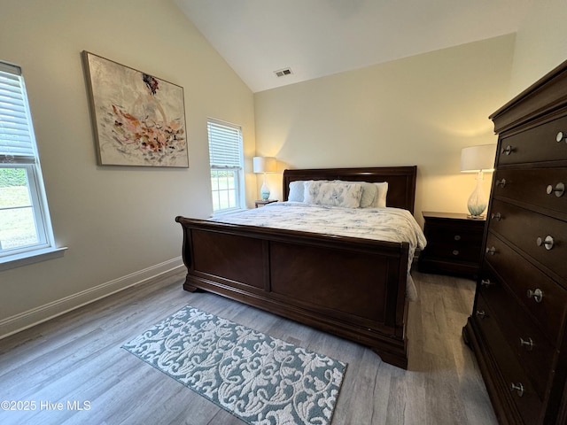 4983 Kona Ct Unit 1, Southport, NC 28461 - bedroom with vaulted ceiling, wood finished floors, and baseboards