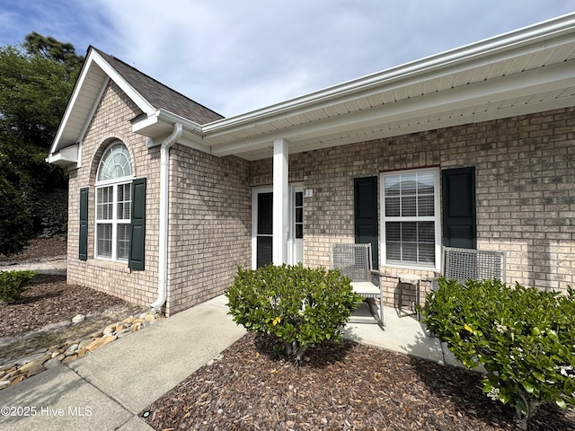 4983 Kona Ct Unit 1, Southport, NC 28461 - view of exterior entry with brick siding and a porch