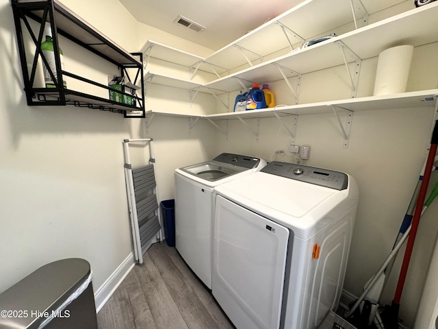 4983 Kona Ct Unit 1, Southport, NC 28461 - laundry room with washer and dryer, wood finished floors, and baseboards