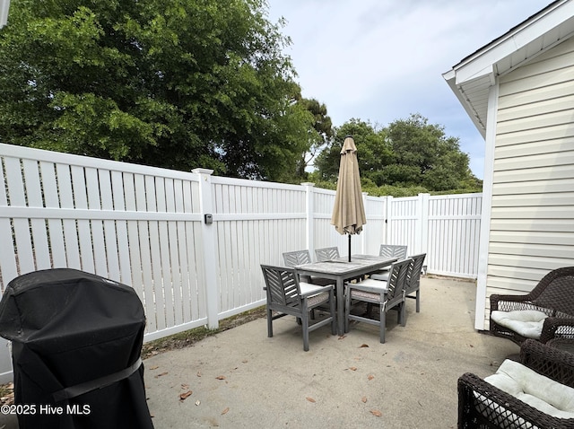 4983 Kona Ct Unit 1, Southport, NC 28461 - fenced backyard featuring outdoor dining space and a patio