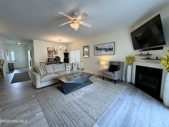 4983 Kona Ct Unit 1, Southport, NC 28461 - living room featuring wood finished floors, a ceiling fan, a fireplace, and baseboards
