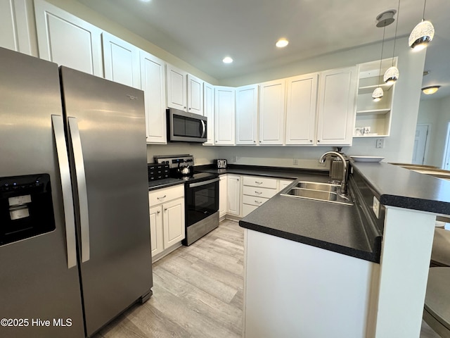 4983 Kona Ct Unit 1, Southport, NC 28461 - kitchen with stainless steel appliances, a sink, a peninsula, dark countertops, and recessed lighting
