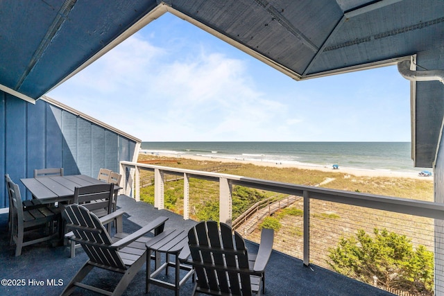 608 Carolina Beach Ave N Unit 3C, Carolina Beach, NC 28428 - balcony featuring a view of the beach, outdoor dining area, and a deck with water view