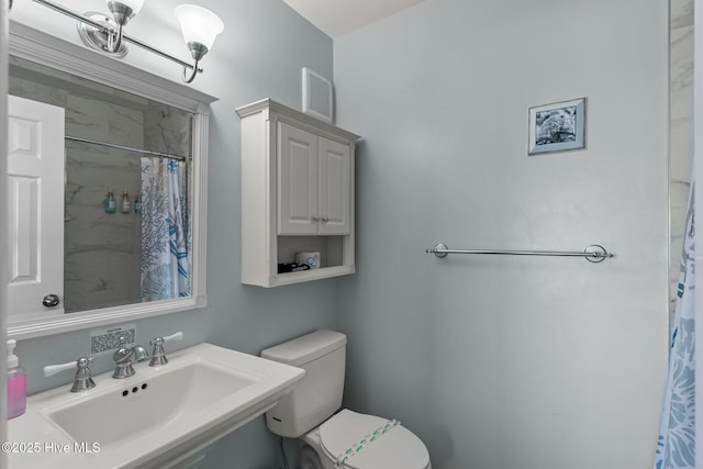 608 Carolina Beach Ave N Unit 3C, Carolina Beach, NC 28428 - full bathroom with a sink, toilet, and a shower with shower curtain